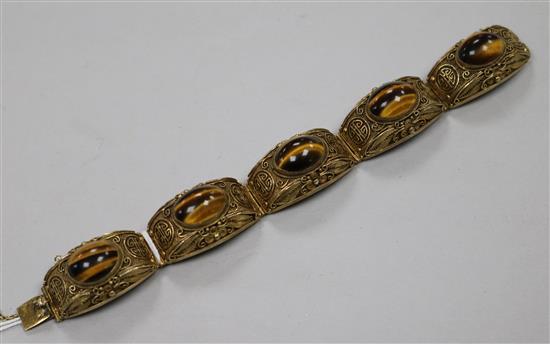 A Chinese silver gilt filligree and cabochon tigers eye quartz set bracelet, 73mm.